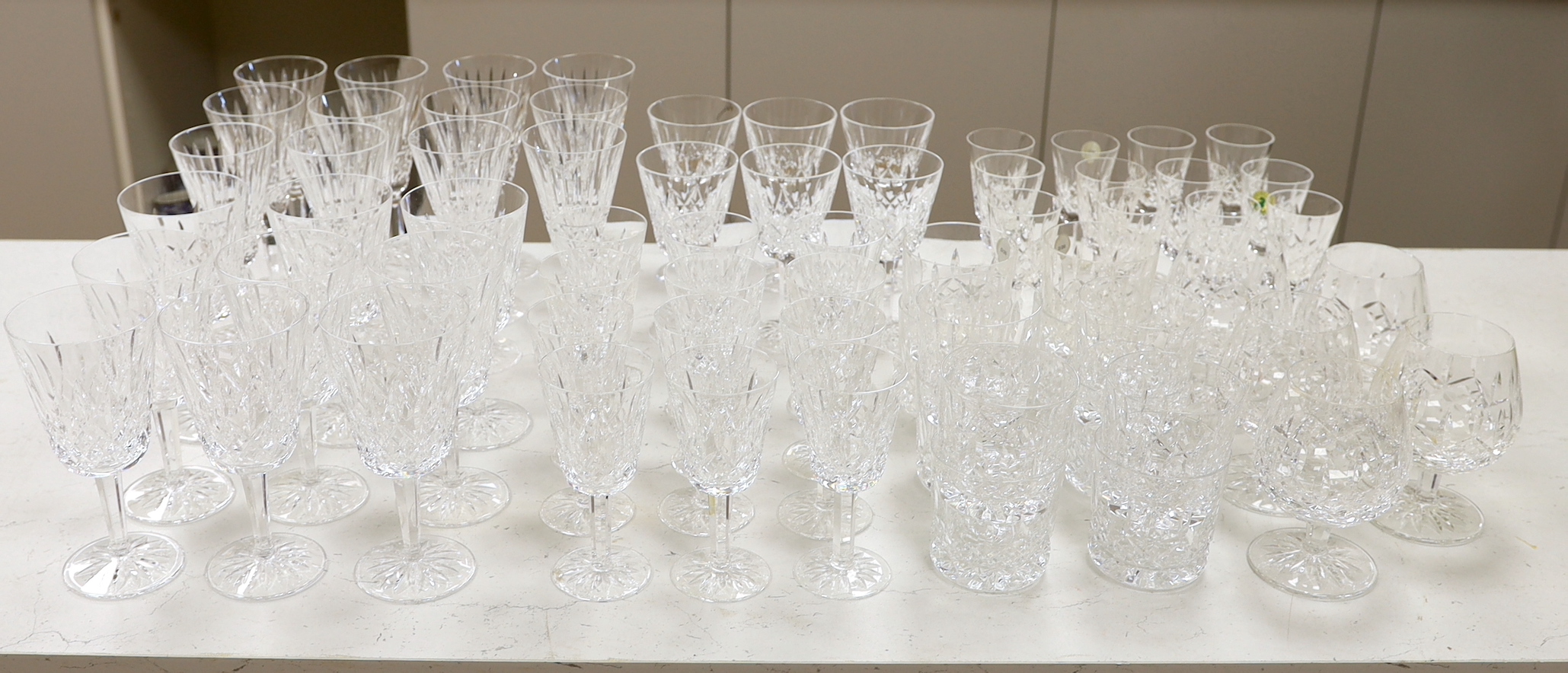 A 68 piece part suite of Waterford cut crystal ‘’Lismore’’ pattern drinking glassware, consisting:- 12 champagne glasses, 9 red wine glasses, 6 white wine glasses, 12 liqueur glasses, 12 whisky tumblers, 12 sherry glasse